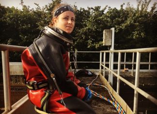 Marie, a female commercial diver in her work suit