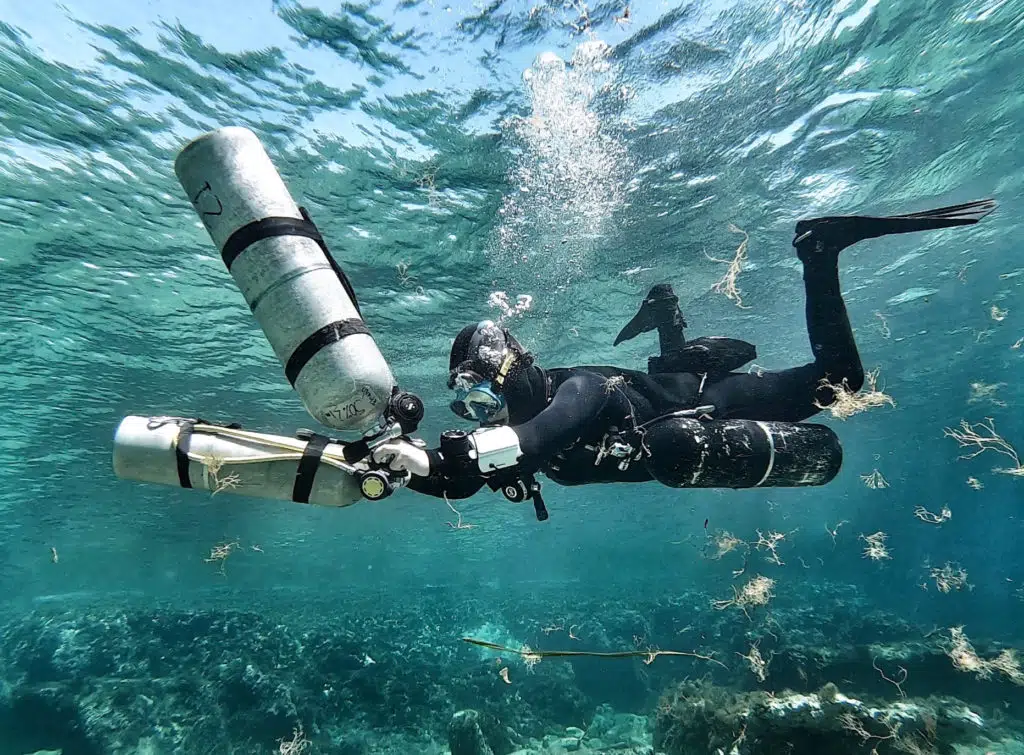 Female tech diver Miranda Bowman with her sidemount configuration
