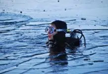 Scuba diver looking worried on the surface of the water. We ask is it safe to scuba dive while pregnant?